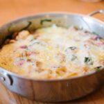 A pan with cheese covered pumpkin egg casserole