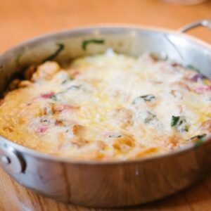 A pan with cheese covered pumpkin egg casserole