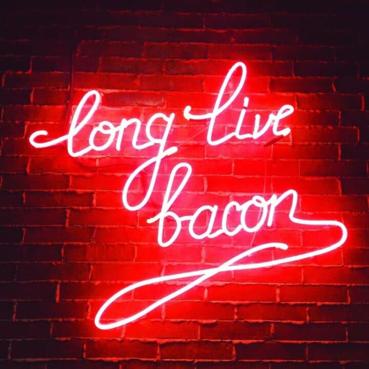 red neon sign saying "long live bacon" in cursive.