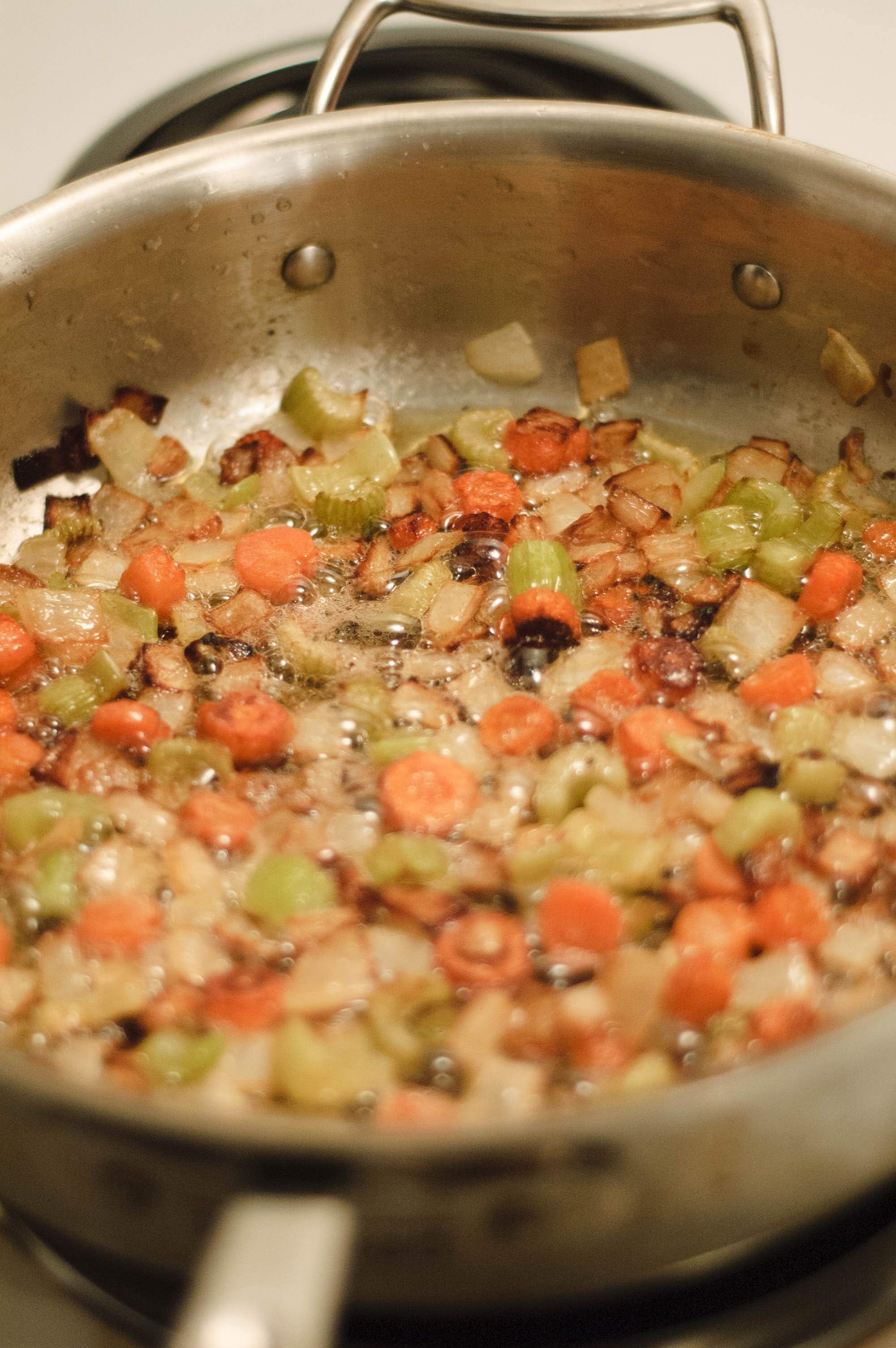 Browned mirepoix in a sauce pot preparing for espagnole sauce.