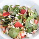 Enjoy this light and sweet strawberry, almond, and goat cheese salad that has a bright and zingy strawberry vinaigrette. The almonds give it a great crunch!
