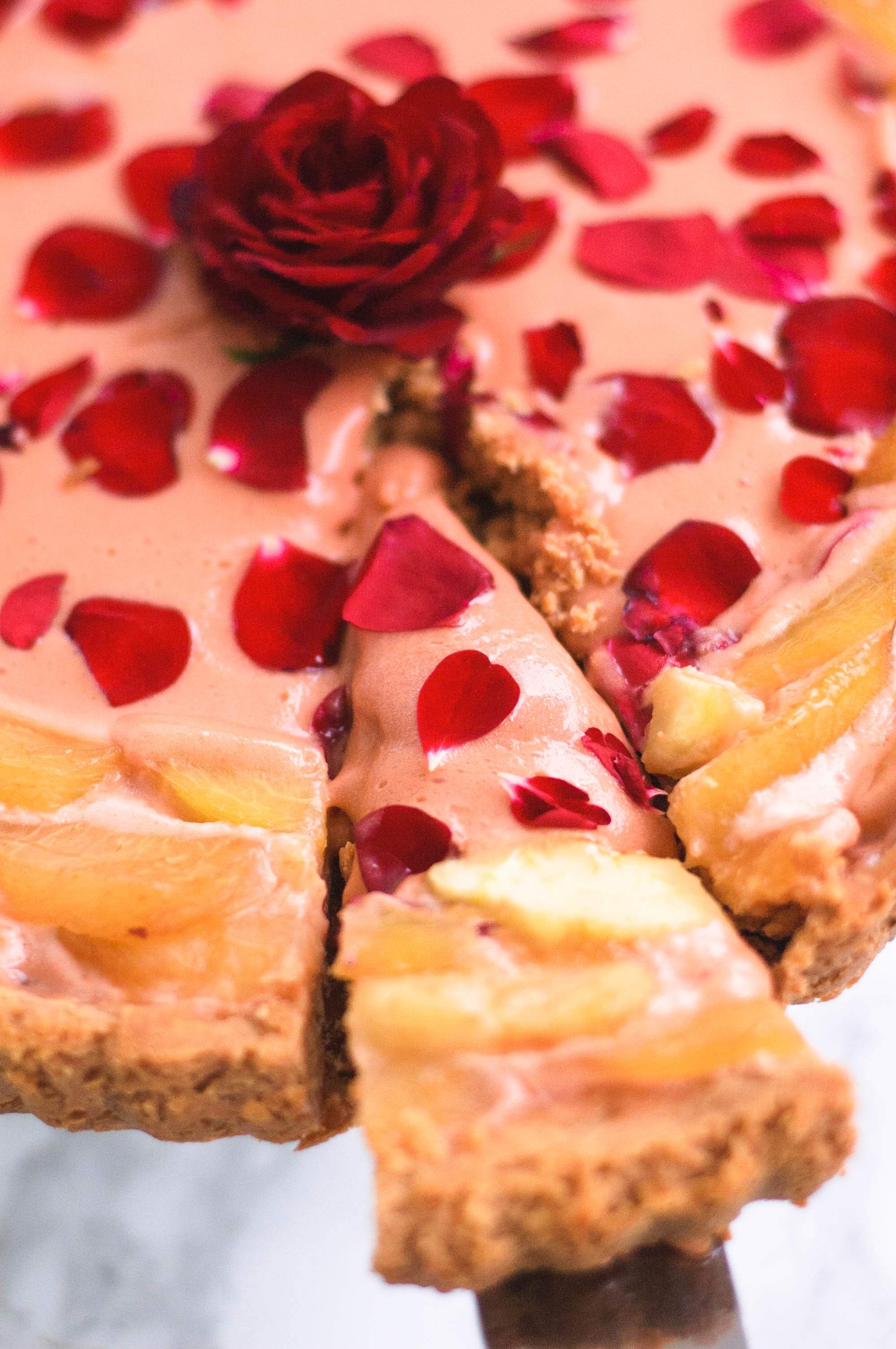 A slice being removed from the rose curd and white peach tart