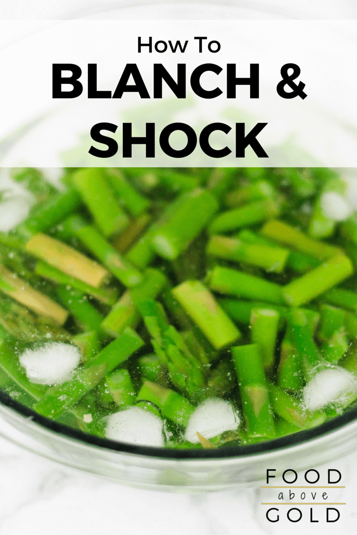 Asparagus being shocked in a bowl of ice water after being blanched. Text says "how to blanch and shock."
