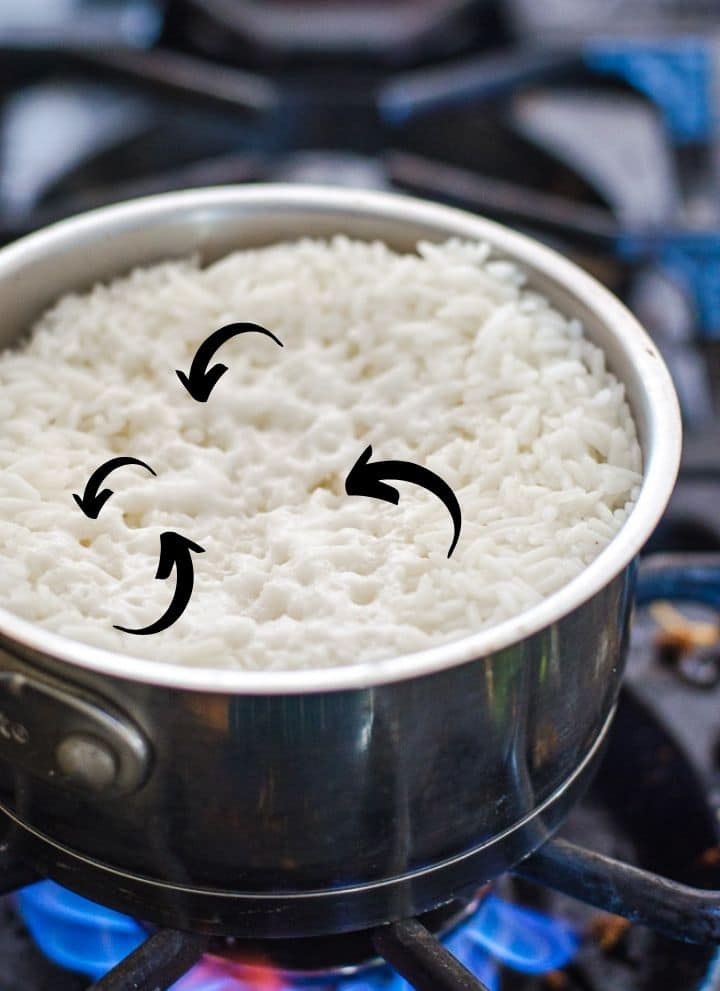 Arrows pointing to the holes that form when rice is cooked correctly.