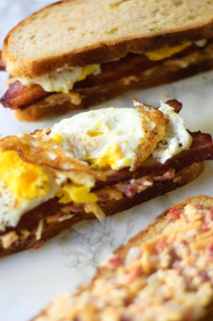 Close up of fried eggs on a sandwich.