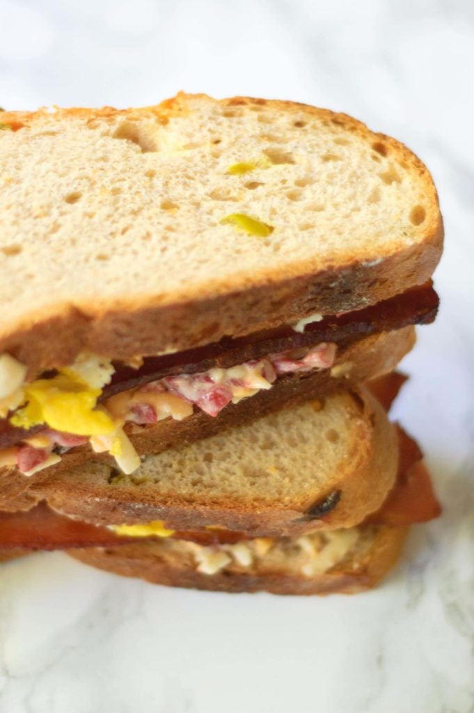 A stack of pimento cheese and fried egg sandwiches.