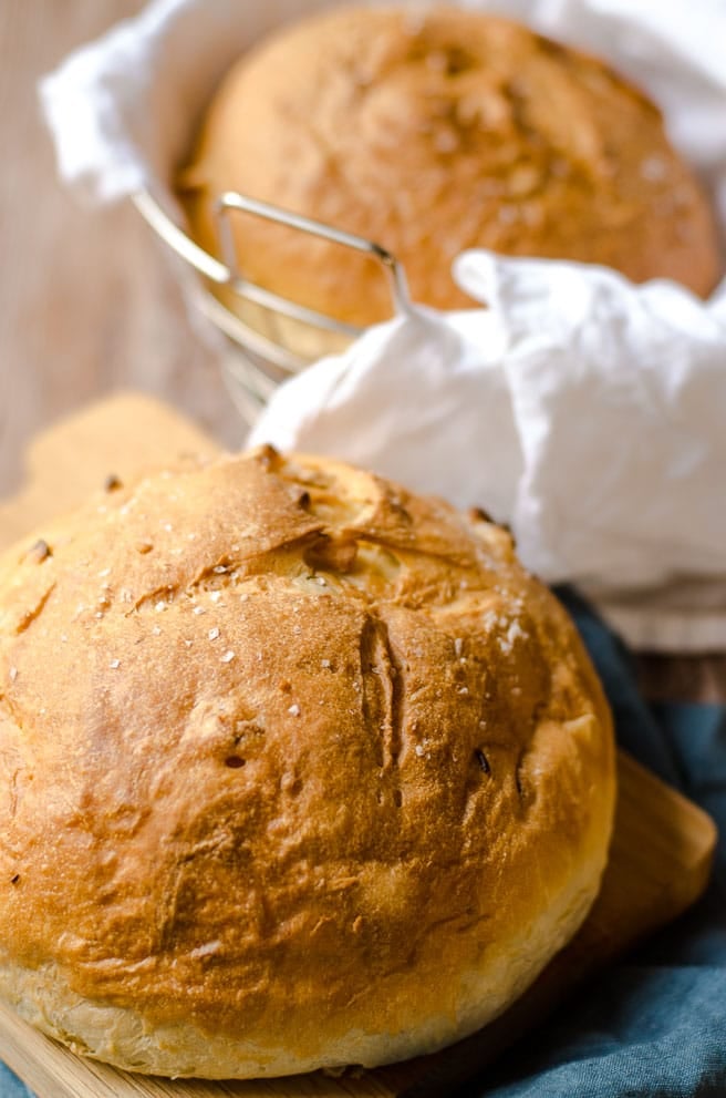 Two loaves of olive oil bread. One in a basket