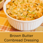 closeup of Brown Butter Dressing with Garlic and Herbs in white bowl on orange plaid tablecloth