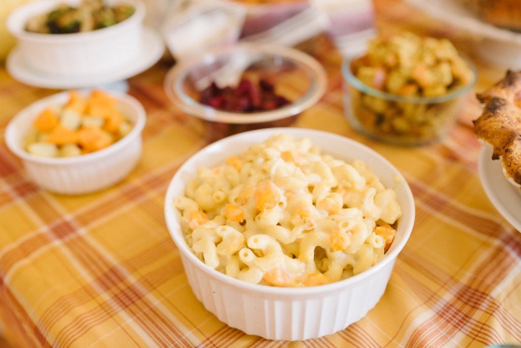 Creamy mac and cheese on a Thanksgiving tables with other side dishes