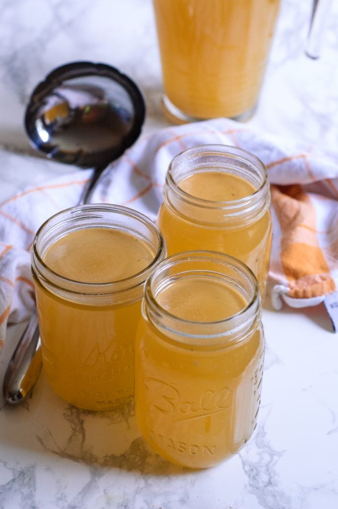 Three quart jars filled with homemade turkey stock