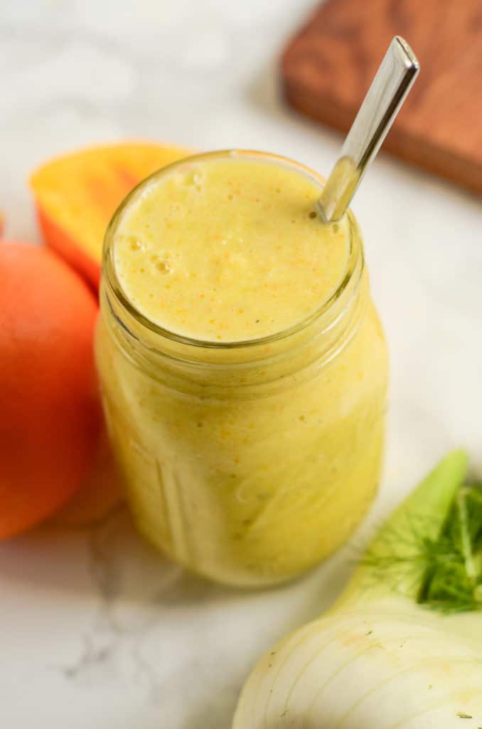 A mason jar filled with marinade. A spoon is in the jar.