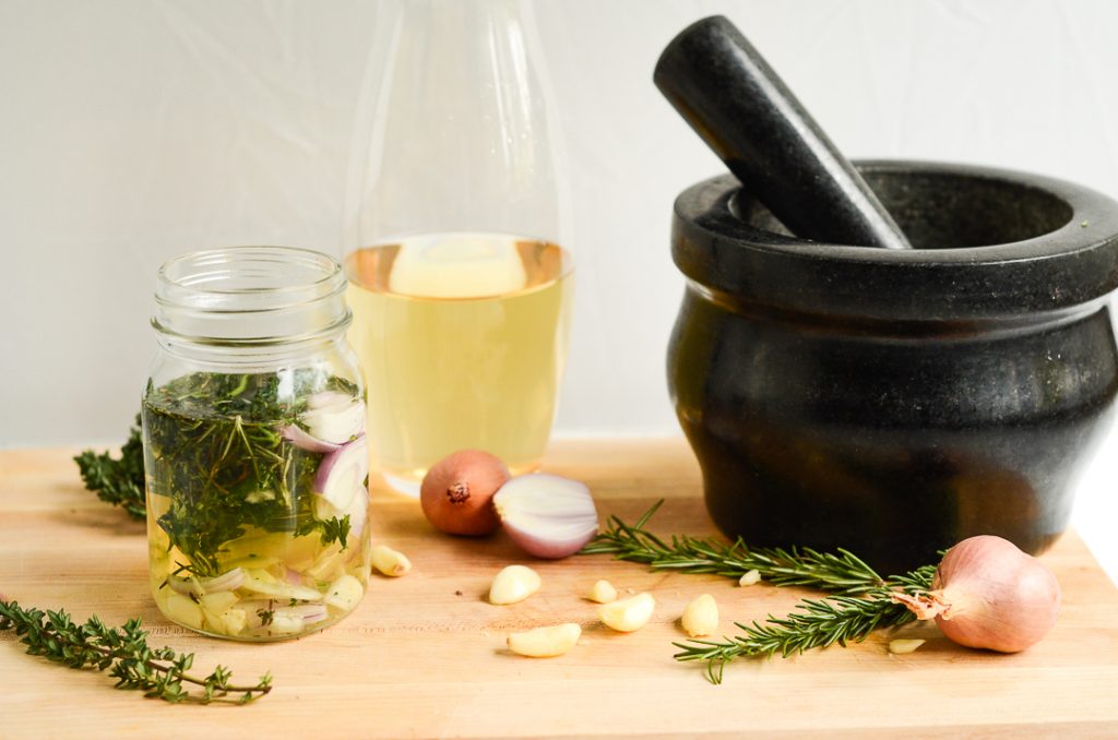 a mortar and pestle and ingredients on a cutting board.