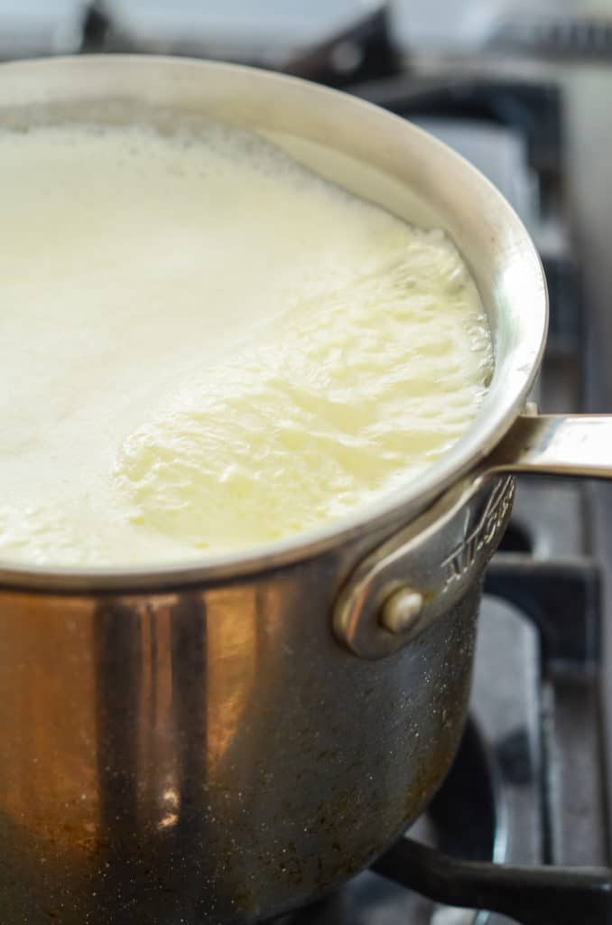 Pot of milk being scalded on cooktop