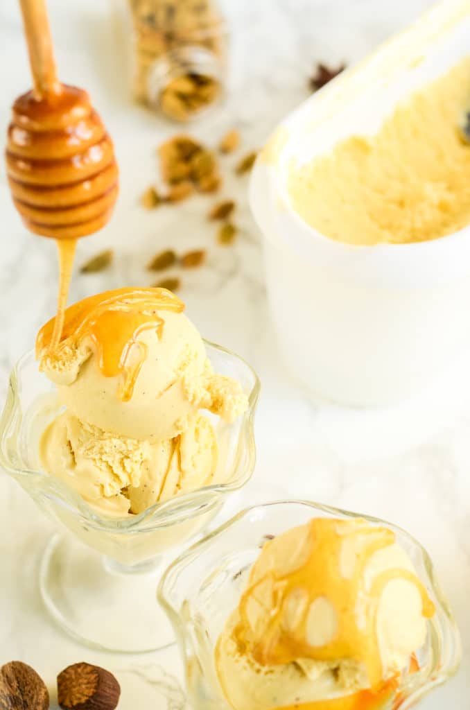 Sundae cups of sexy spices and wildflower honey ice cream being drizzled with honey