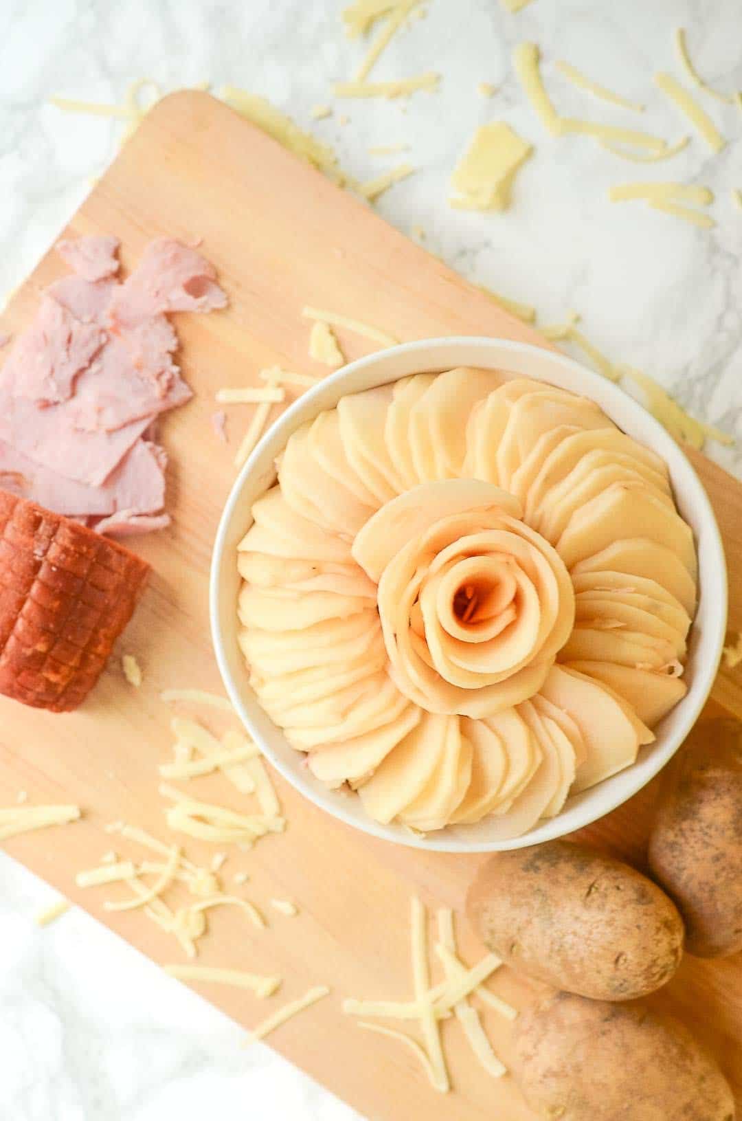 overhead view of Ham and Swiss Au Gratin next to cut ingredients