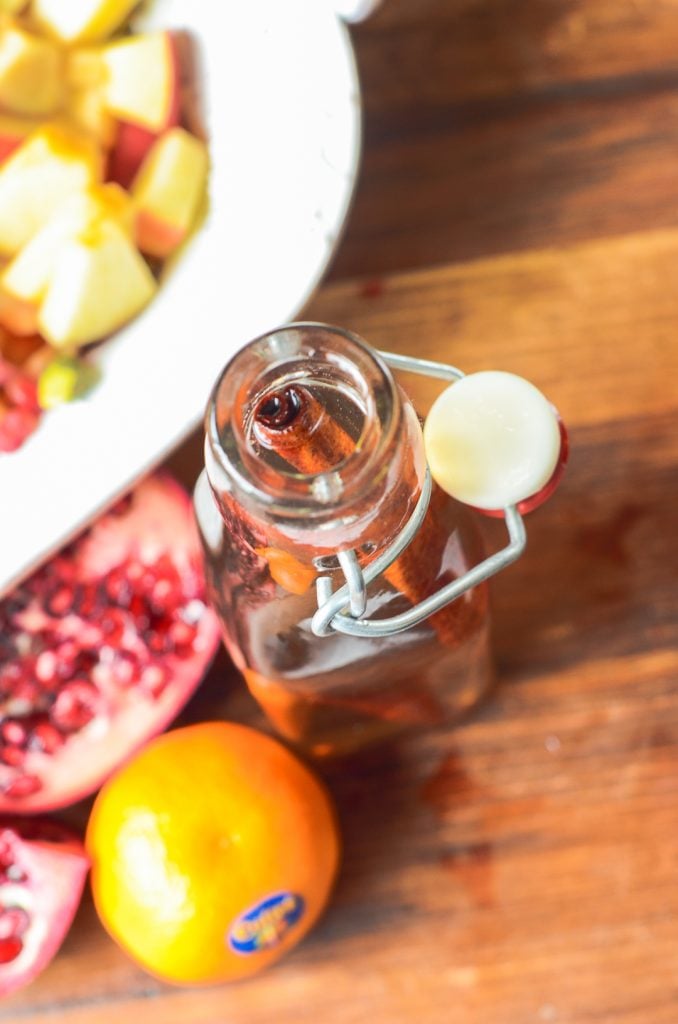 overhead shot of the cinnamon vanilla dressing in a jar with a cinnamon stick poking out