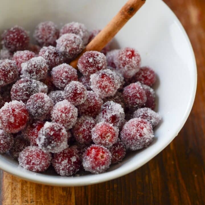 A bowl filled with sugar covered cranberries