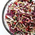 One clear bowl filled with festive winter cabbage slaw