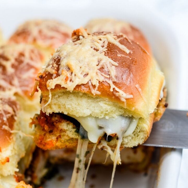 A stringy cheese chicken slider topped with cheese