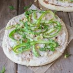 One whole flatbread pizza on top of parchment paper