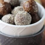 sunflower fig balls inside of stacked white and grey bowls