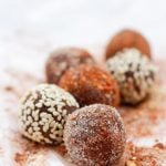 closeup of eight truffles on chile powder