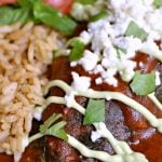 close up of Chilies Rellenos with sour cream next to rice