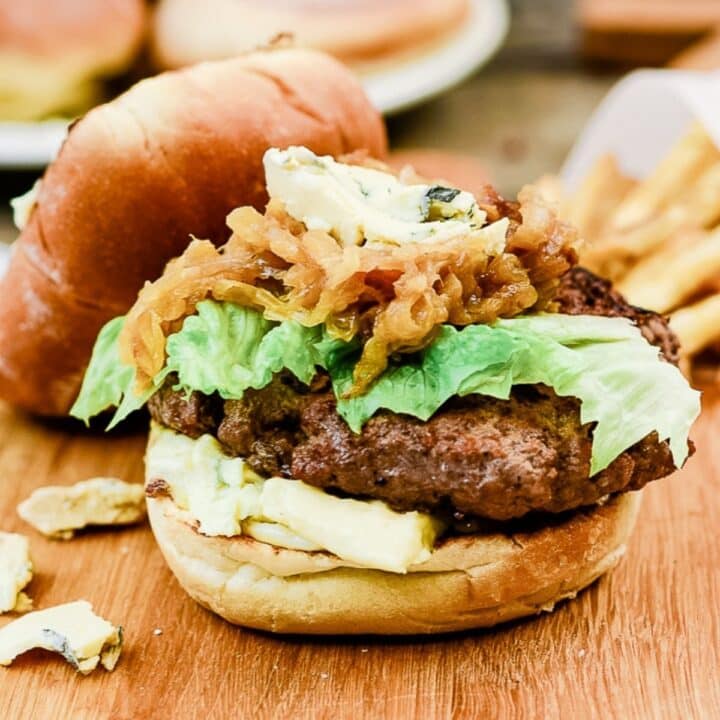 A burger filled with meat, lettuce and more