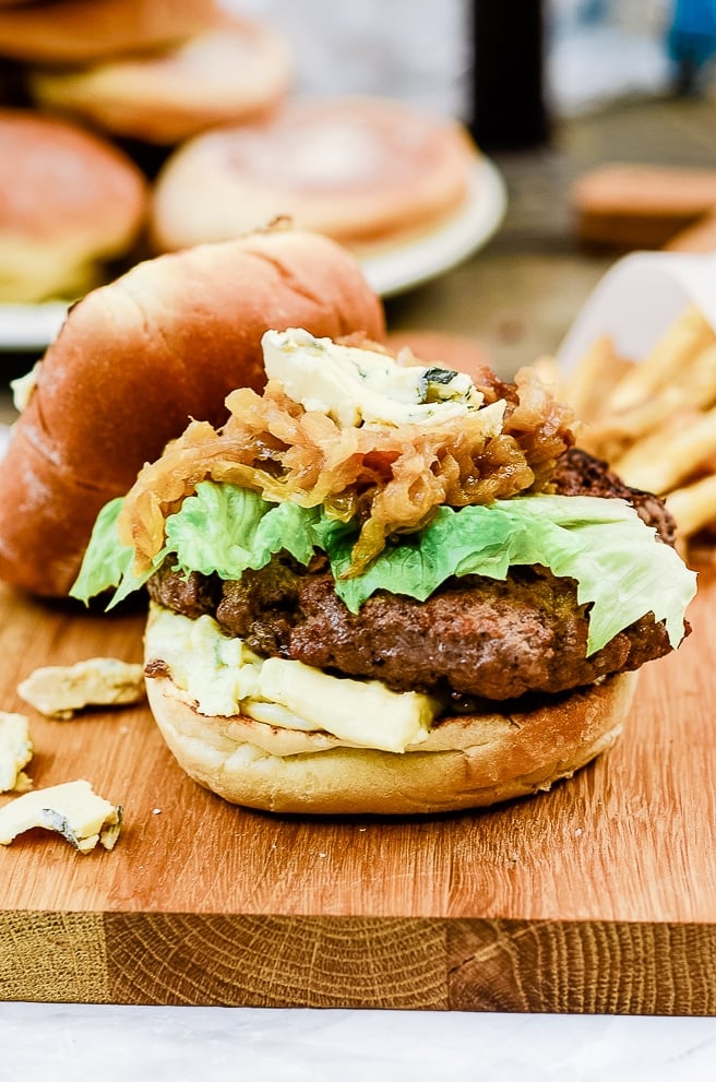 side view of the roasted garlic burger layers. and bun next to it.