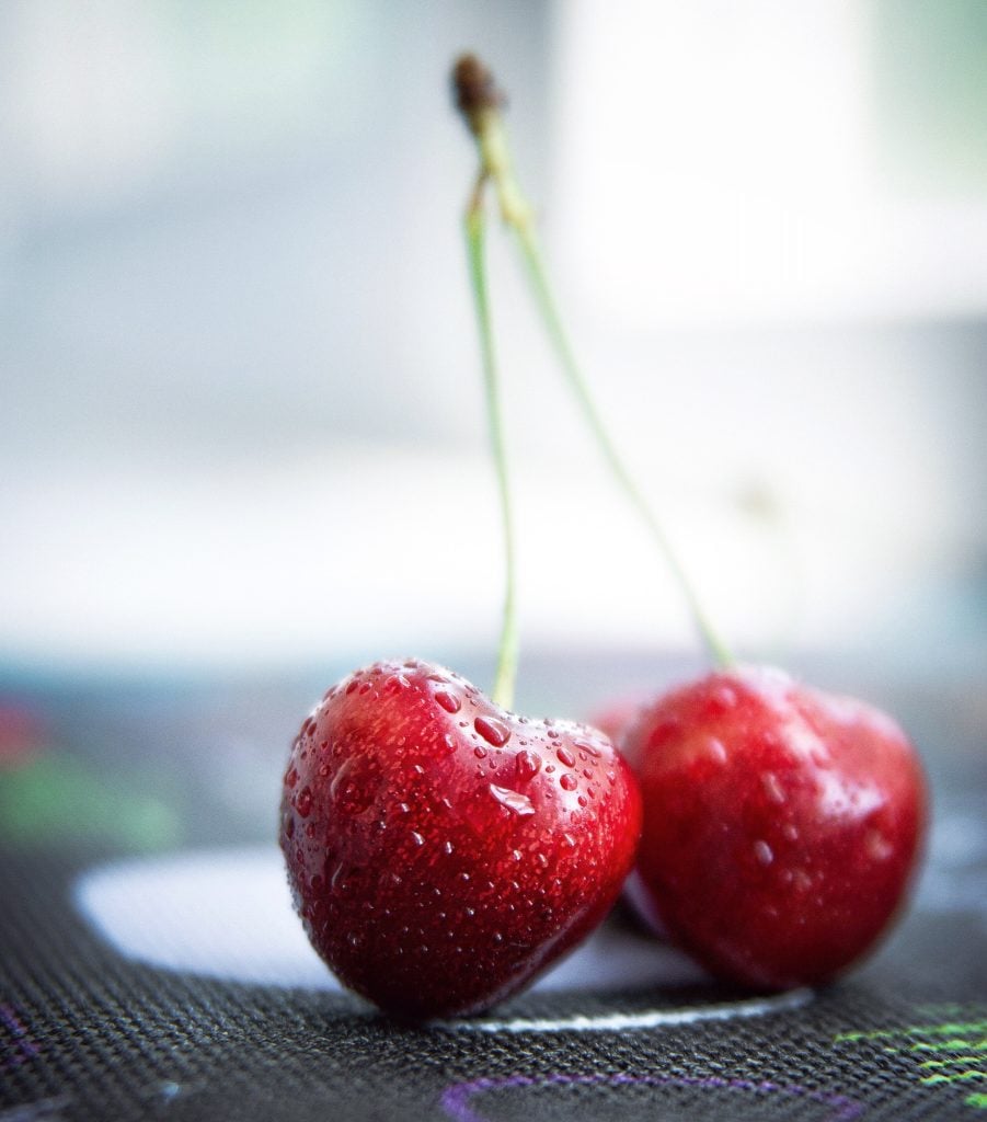 Water droplets on red cherries.