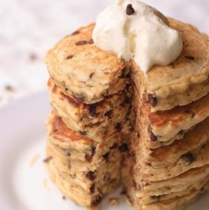 plate of Chocolate Chip Pancakes with Toasted Coconut topped with whipped cream