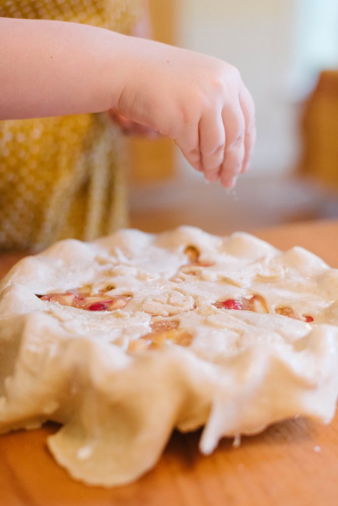 Turbinado sugar being sprinkled onto a completed pie. How To Make Pie Crust