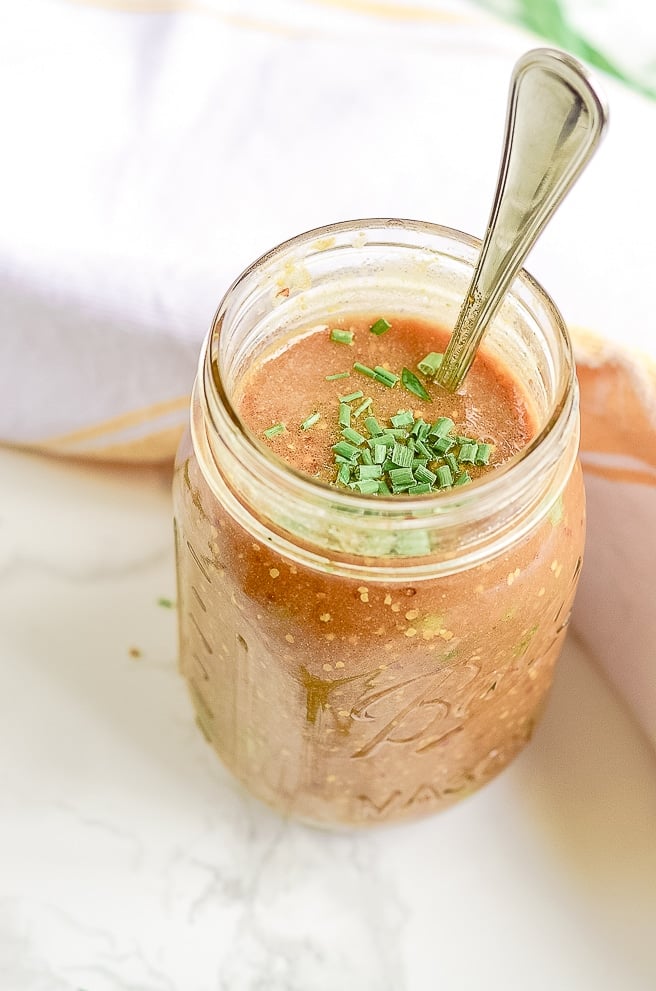 mason jar filled with pork chop marinade next to a towel