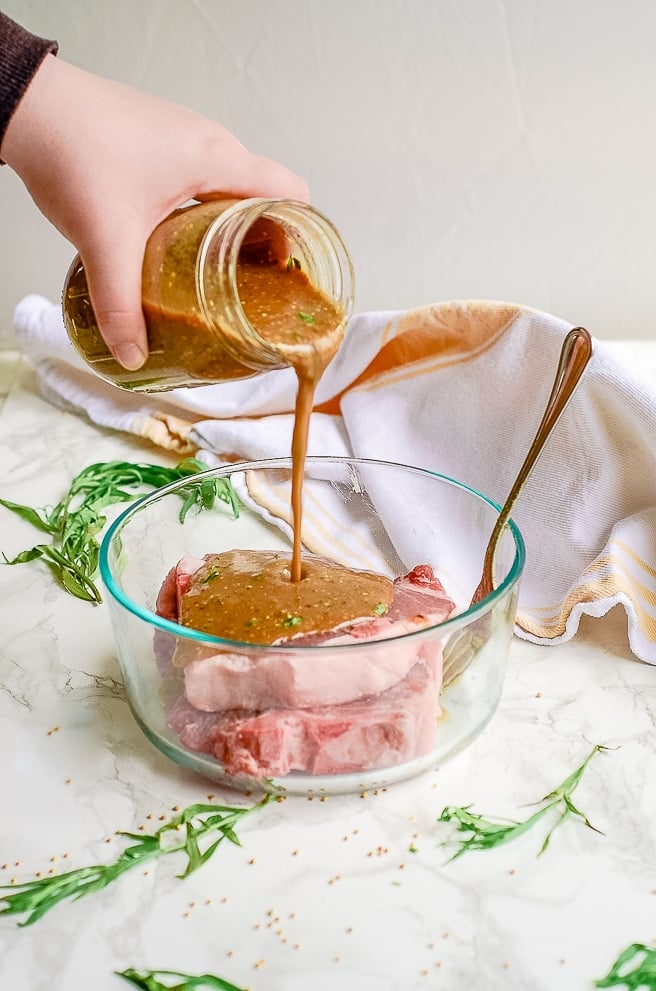 pork chop marinade being poured over pork chops