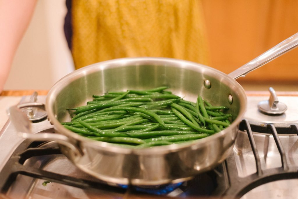 haricots verts in a pan on the cooktop.