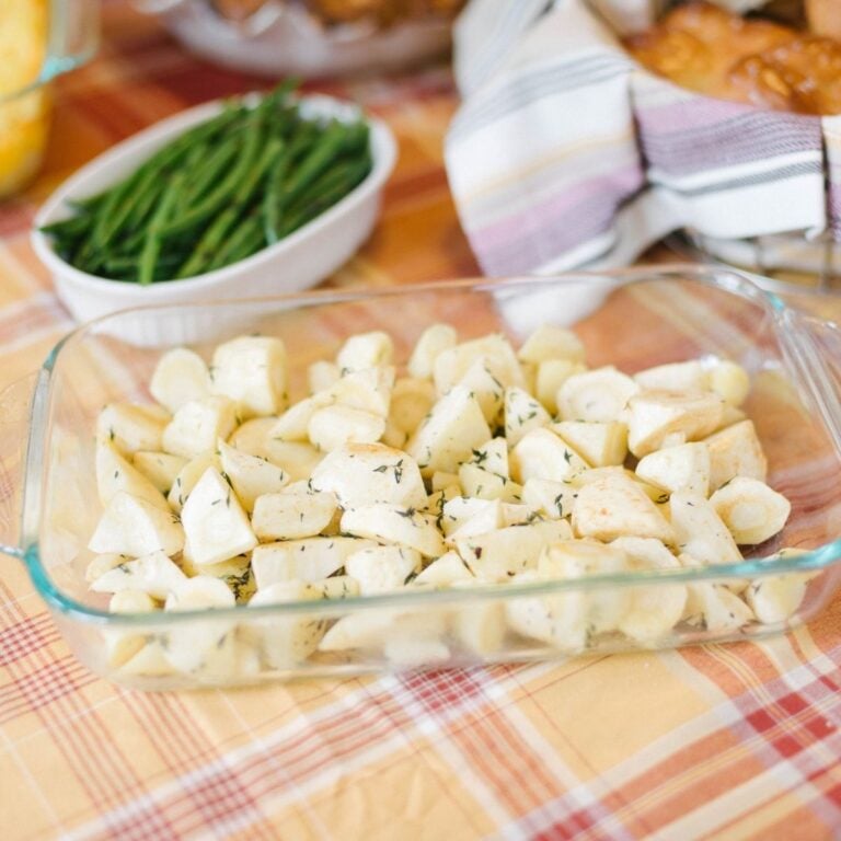 A glass pan filled with chopped parsnips