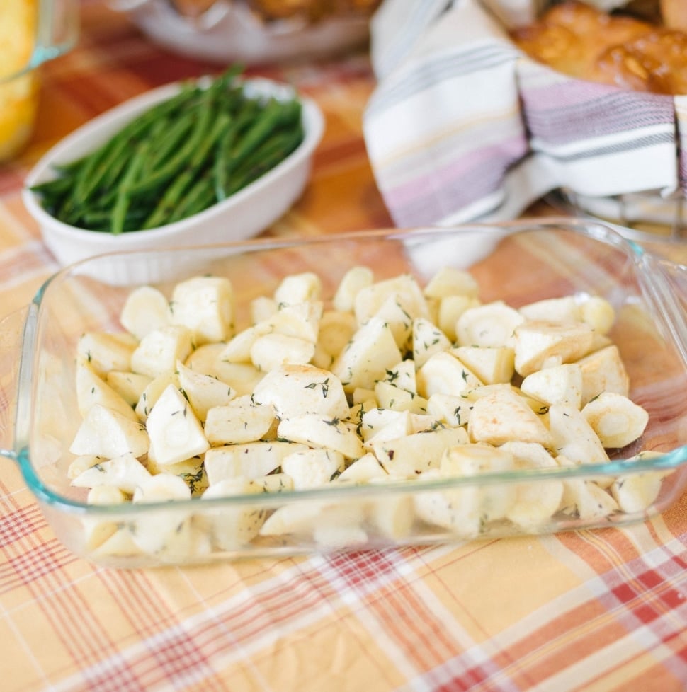 A clean dish of easy roasted parsnips on an autumnal colored tablecloth