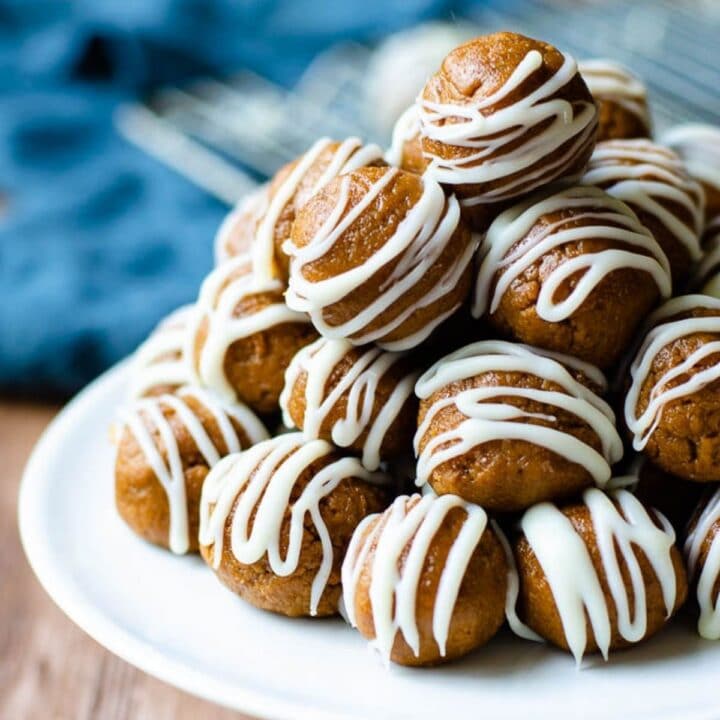 tray of biscoff cookie truffles on a wooden board with a blue napkin behind it