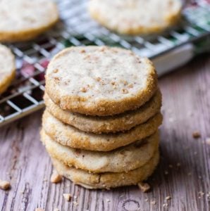 five shortbread cookies stacked in front of a cooling rack