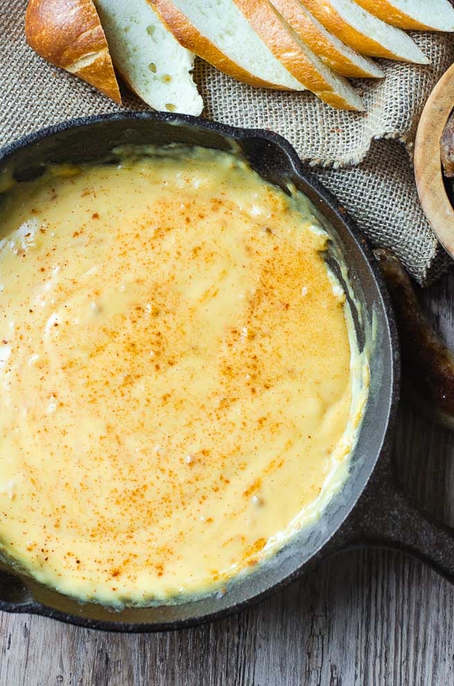 A cast iron pan filled with beer cheese dip