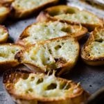slices of homemade garlic toast on a sheet pan