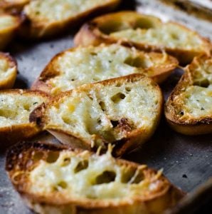 slices of homemade garlic toast on a sheet pan