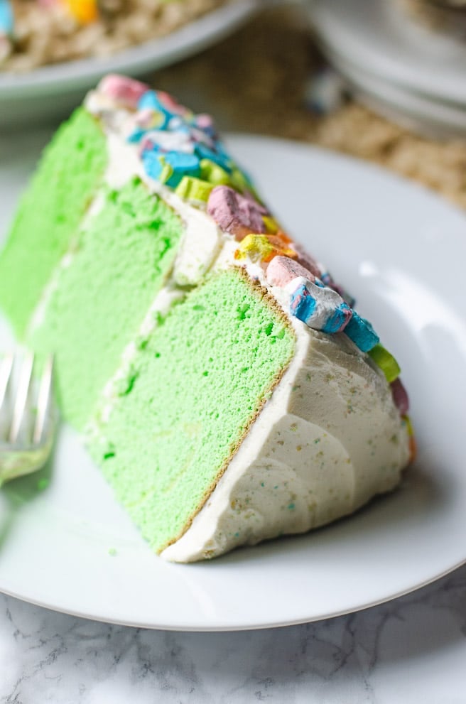 A slice of ombre green cake layers next to a fork