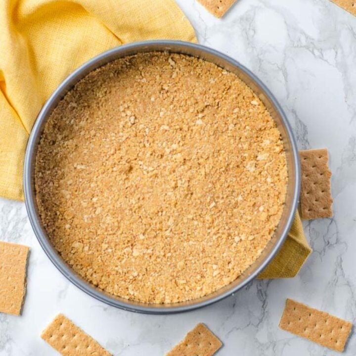 A cake pan filled with graham cracker crumbs