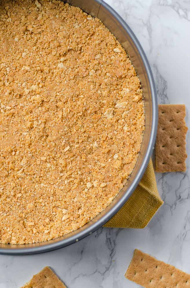 close up of the graham cracker crust in a springform pan