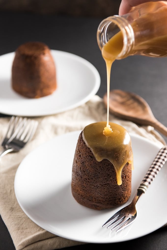 syrup being poured on sticky toffee pudding cake