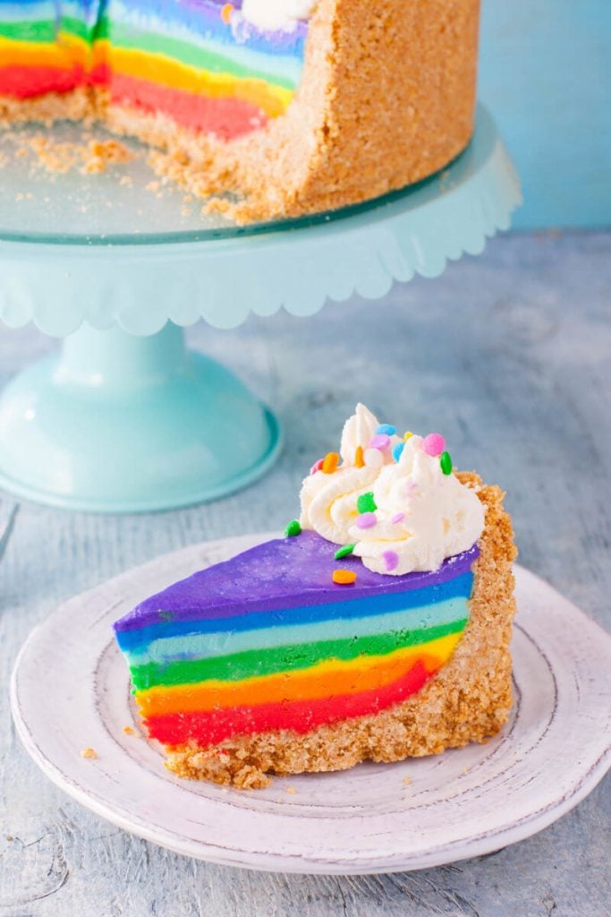 close up of a piece of no bake rainbow cheesecake
