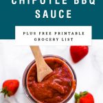 A mason jar of strawberry bbq sauce with a wooden spoon dipping in. Recipe title above it is on a blue background.