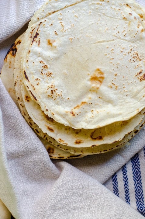 overhead image of a stack of homemade corn tortillas