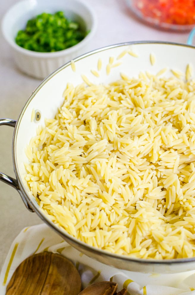cooked orzo pasta in a colander.